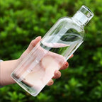 Woman holding a transparent water bottle outdoors