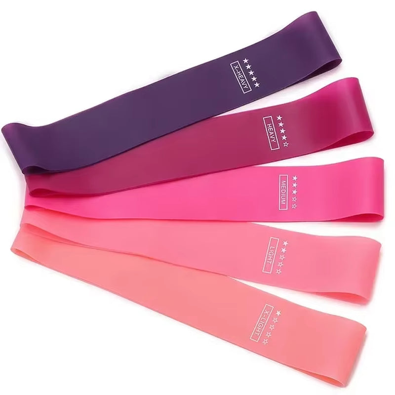 Stack of five loop resistance bands in graduated pink and purple shades showing the full 10–40 lb set