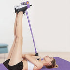Woman using pedal resistance bands for leg exercise on yoga mat