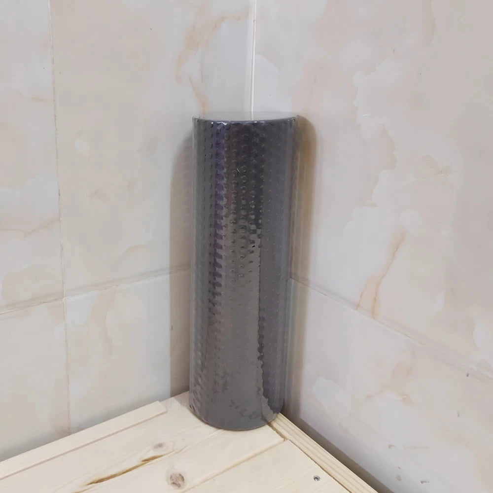 Grey hexagonal EVA foam roller standing upright showing textured surface