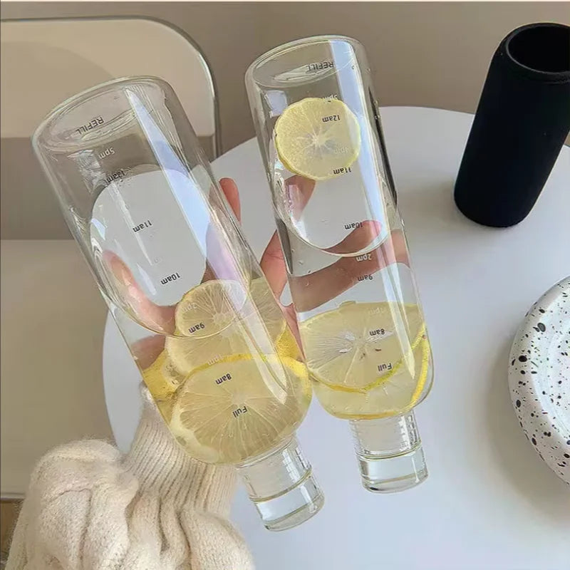 Transparent time marker water bottles with lemon water on a table