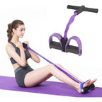 Woman using pedal resistance bands for seated ab exercise