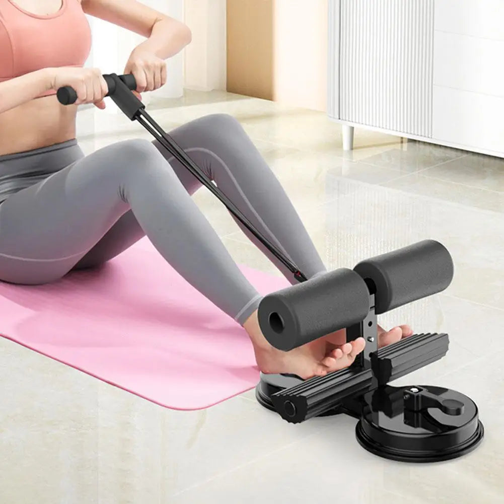Stainless steel sit-up assist bar with foam padding and heel grooves