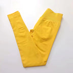 Yellow ribbed waist workout tights worn for yoga