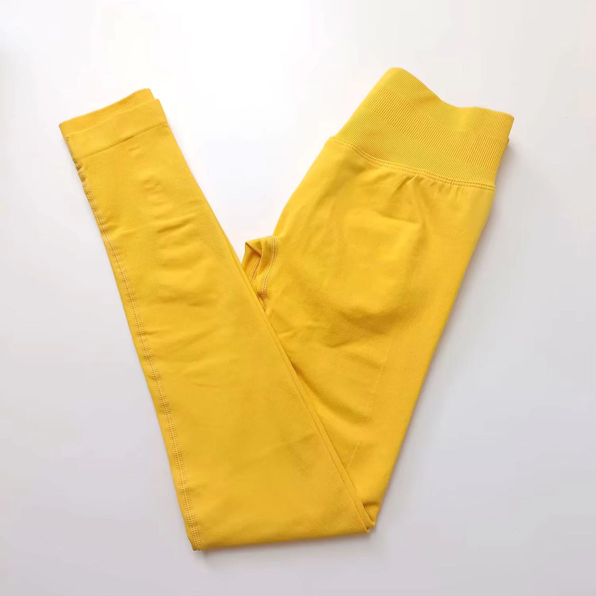 Yellow ribbed waist workout tights worn for yoga